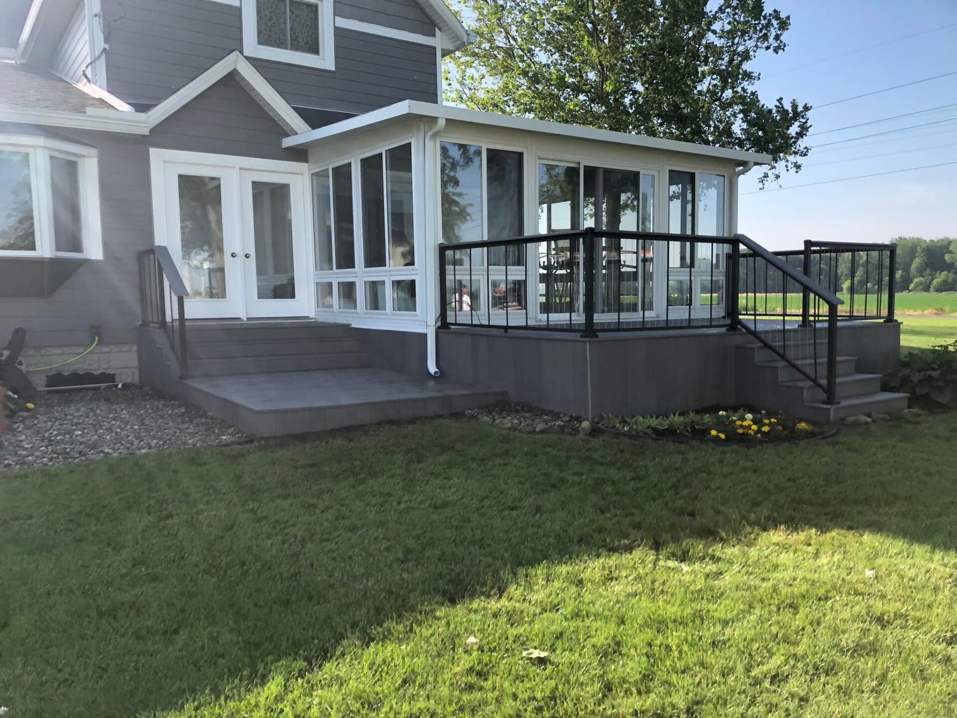 A full view of house with green siding